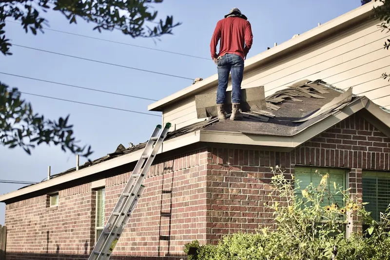 Professional roofer working on a residential roof in Depew